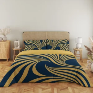 Close frontal view of navy and gold-colored fan-ribbon bedding with two printed pillows and a plain gold-colored fold above the duvet.