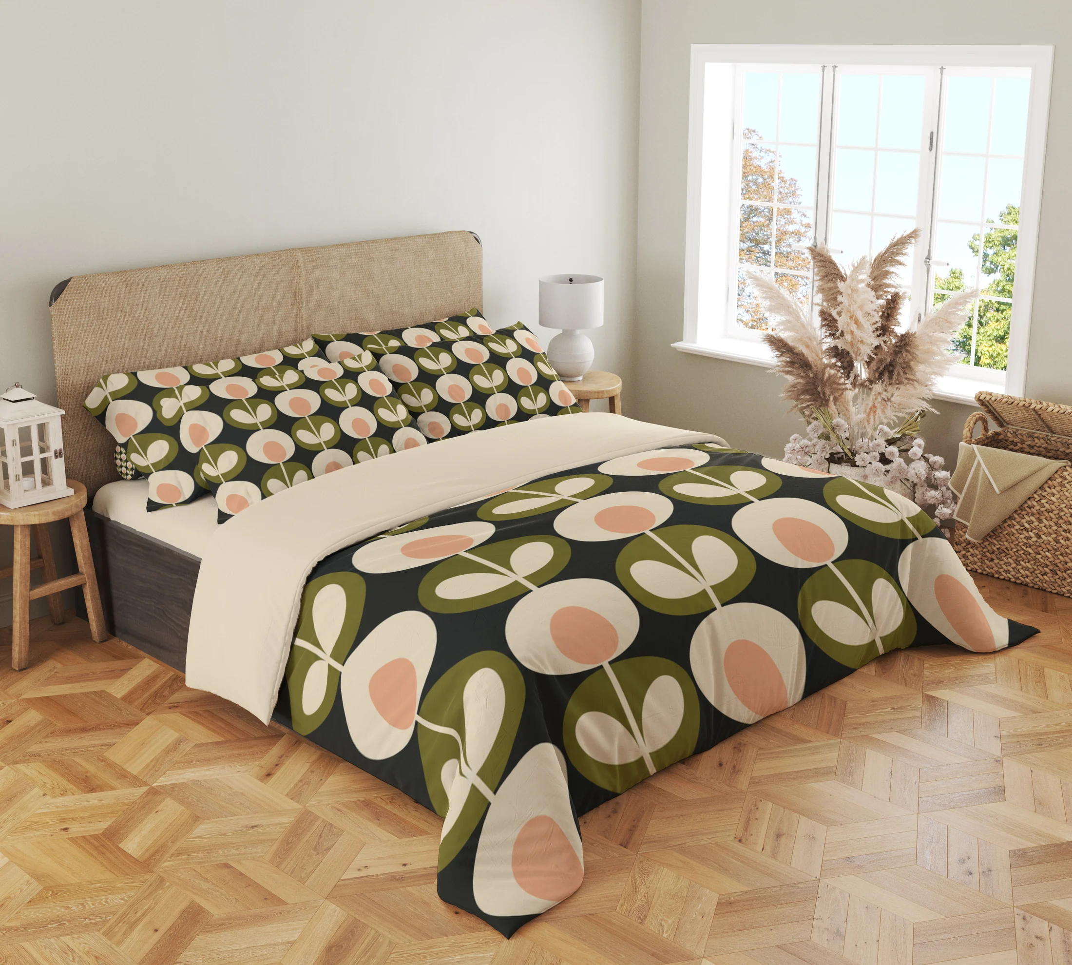 Angled view of peach-centered flowers and olive leaf medallions on a charcoal duvet, with a large flower curving around the draped front corner.