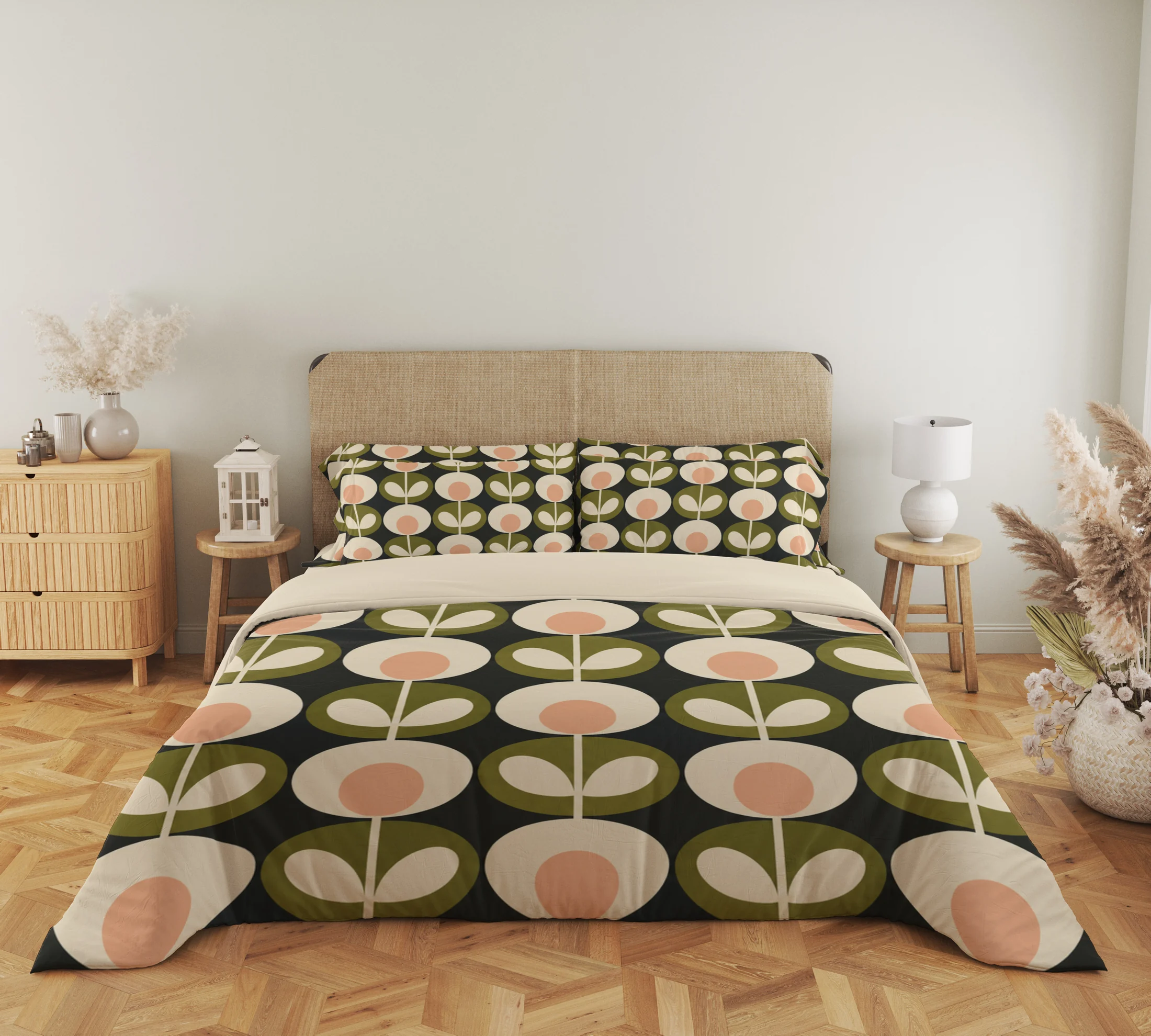 Front view of charcoal bedding with vertical cream stems joining peach-centered flowers and olive leaf medallions, echoed on the pillows.