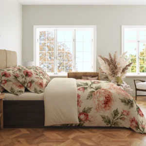 Side view of the cream floral duvet draped beside the bed, showing a large peach peony, rosy flowers and olive stems below the turned-back cover.