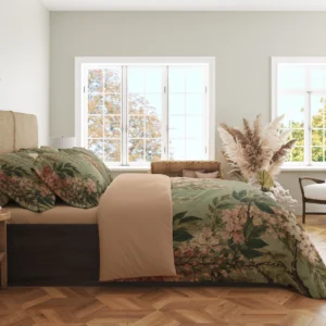 Side view of a sage floral duvet cover, with cream and rose hanging flower clusters along the draped side and a peach-beige turned-back top.