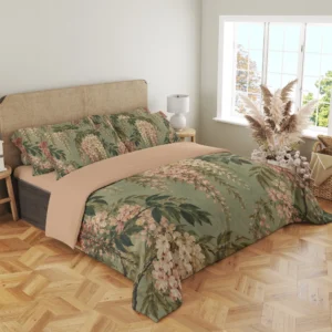 Angled view of the sage floral duvet cover with tapering cream and rose clusters, dark stems and matching pillows above the peach-beige turned-back cover.