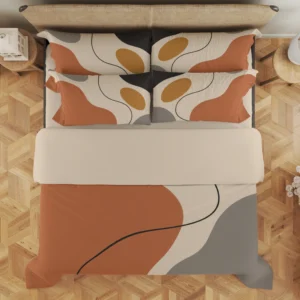 Overhead view of terracotta, cream and gray abstract bedding with a curved charcoal line, a cream fold and four styled printed pillows.