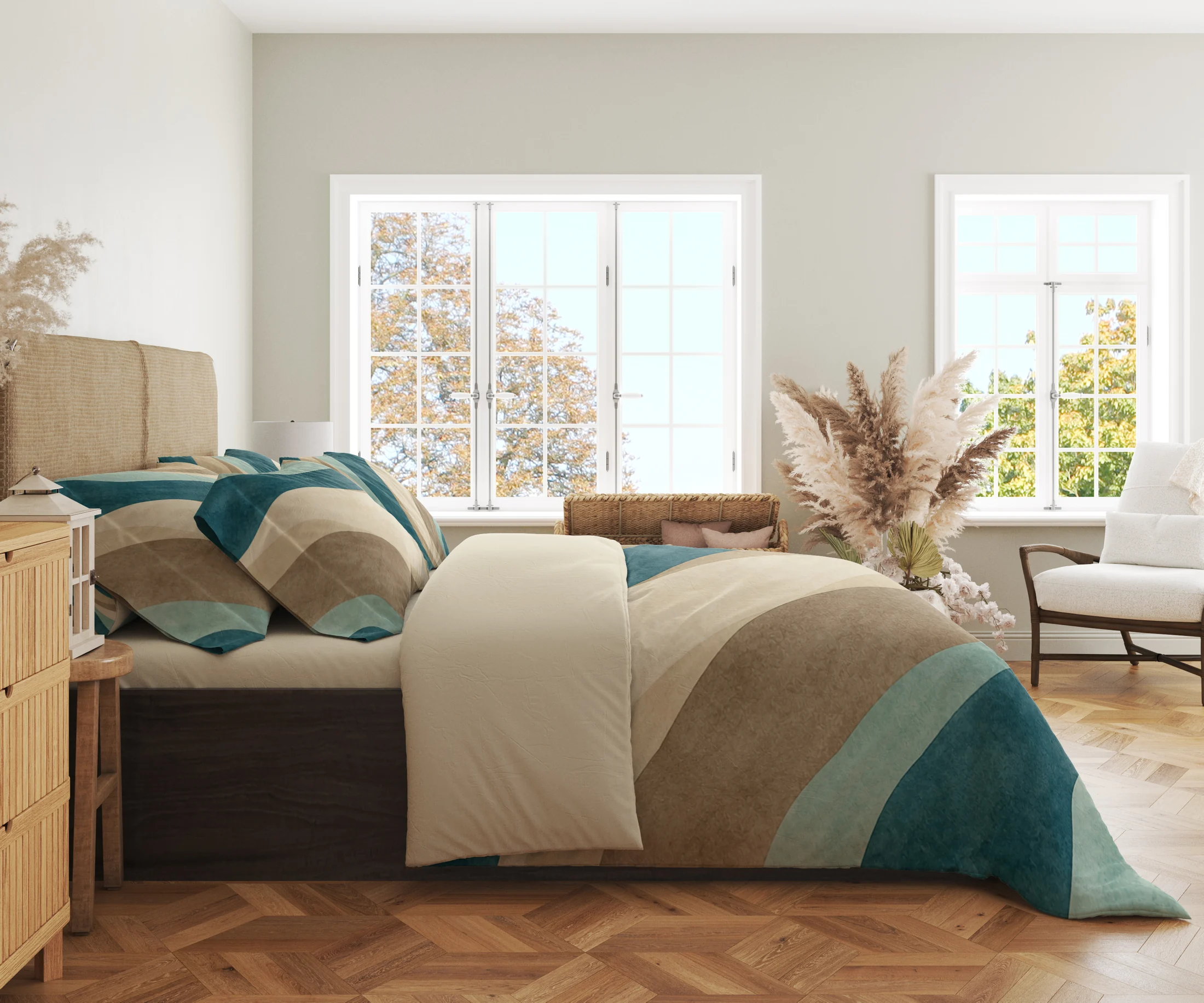 Side view of teal, seafoam and sandy curved-band bedding with printed pillows and a wide cream fold in a bright windowed room.