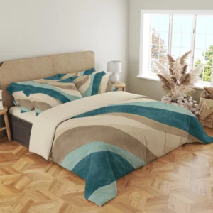 Three-quarter view of teal, seafoam and sand banded bedding with printed pillows and curved bands draping over the front corner beside a woven headboard.